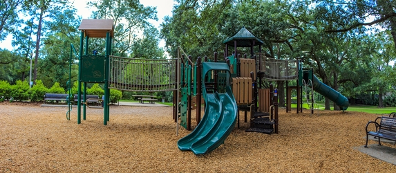 Children Playing On Playground In City Park Engaged In Football