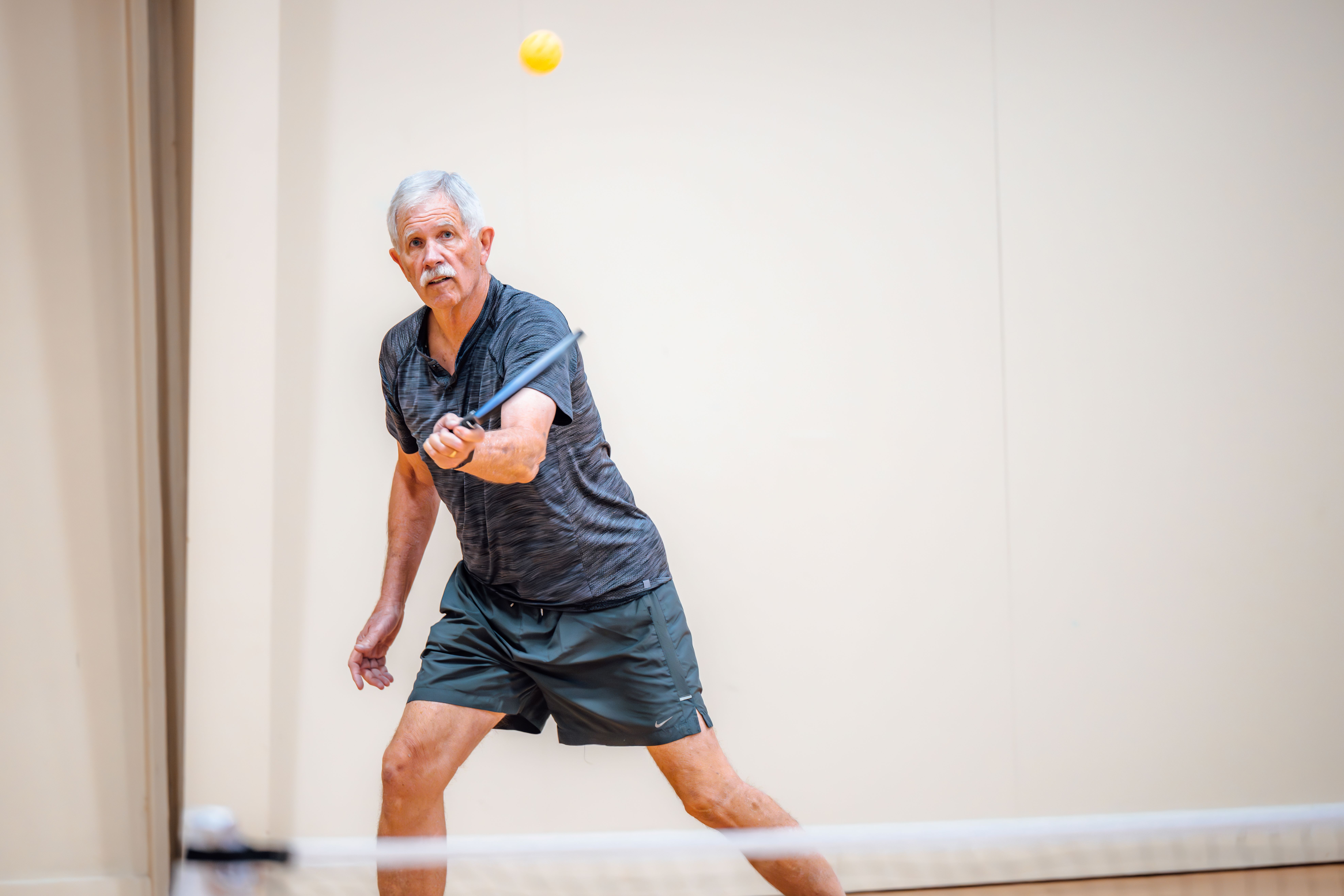 adult male playing pickleball