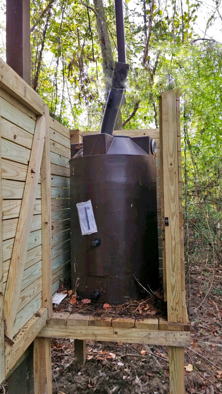 Photo of rain barrel collecting water through pipe