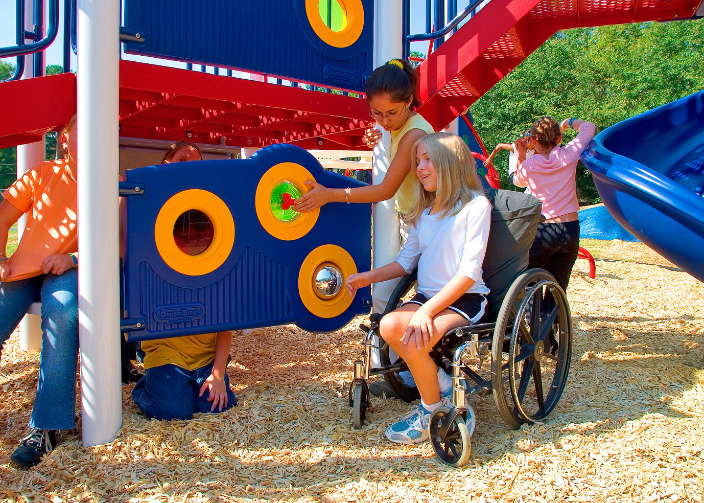 Child in wheelchair interacting with interpretive music panel.