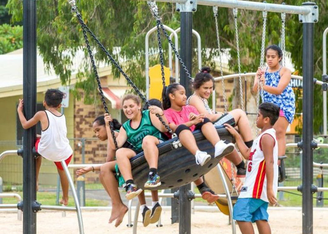 Children playing on group swing