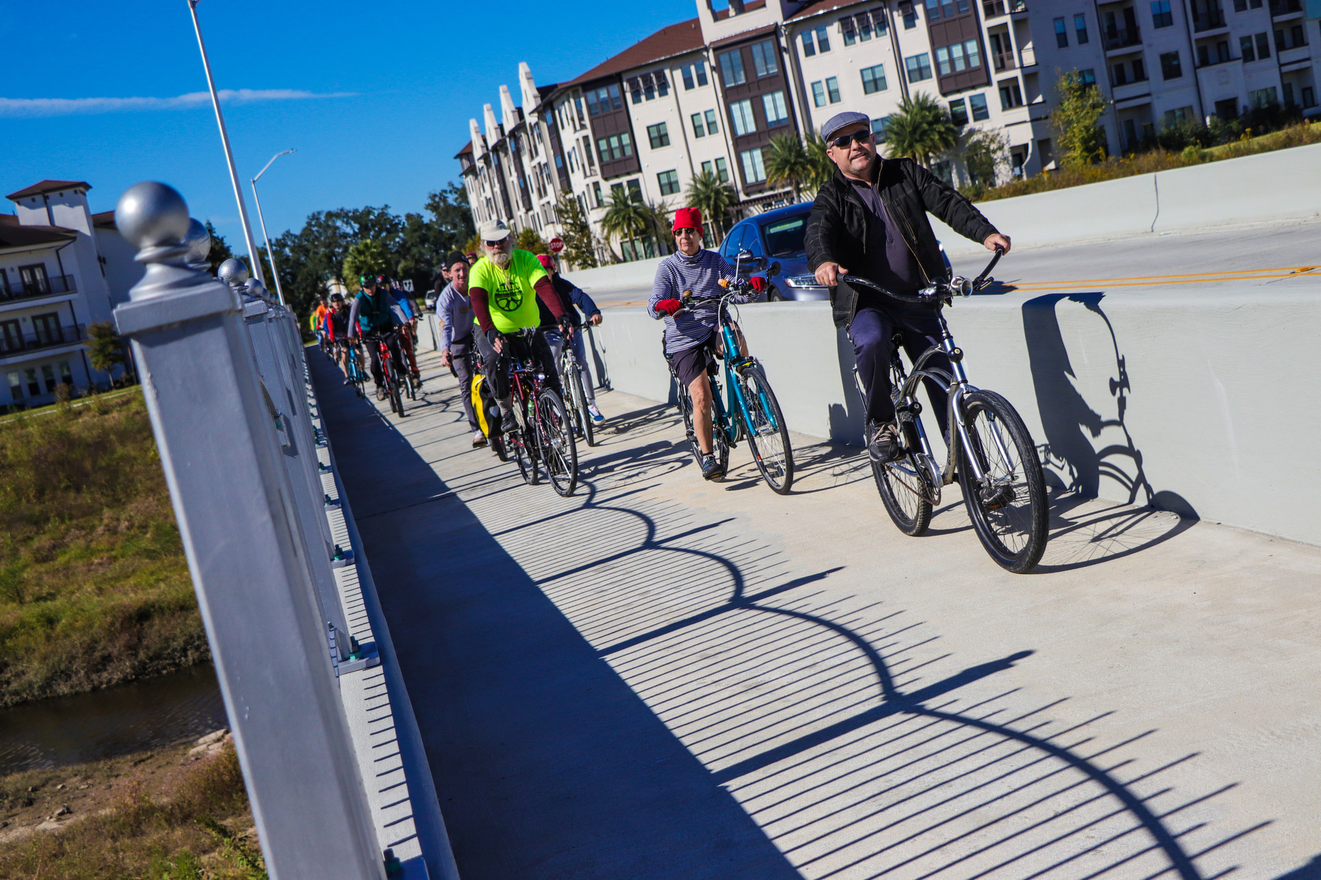 people riding bikes on cement trail