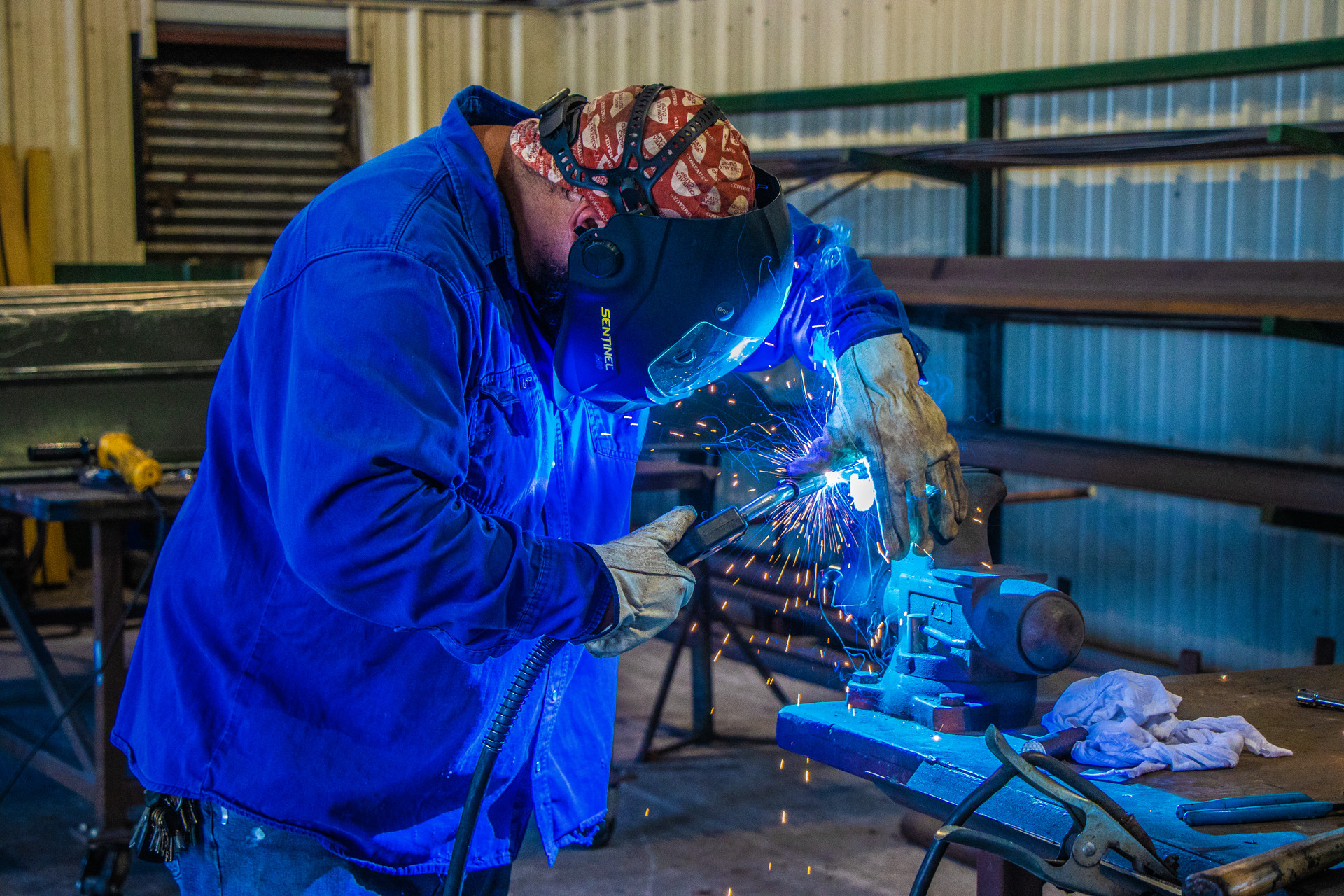 Man welding with welding mask and gear on